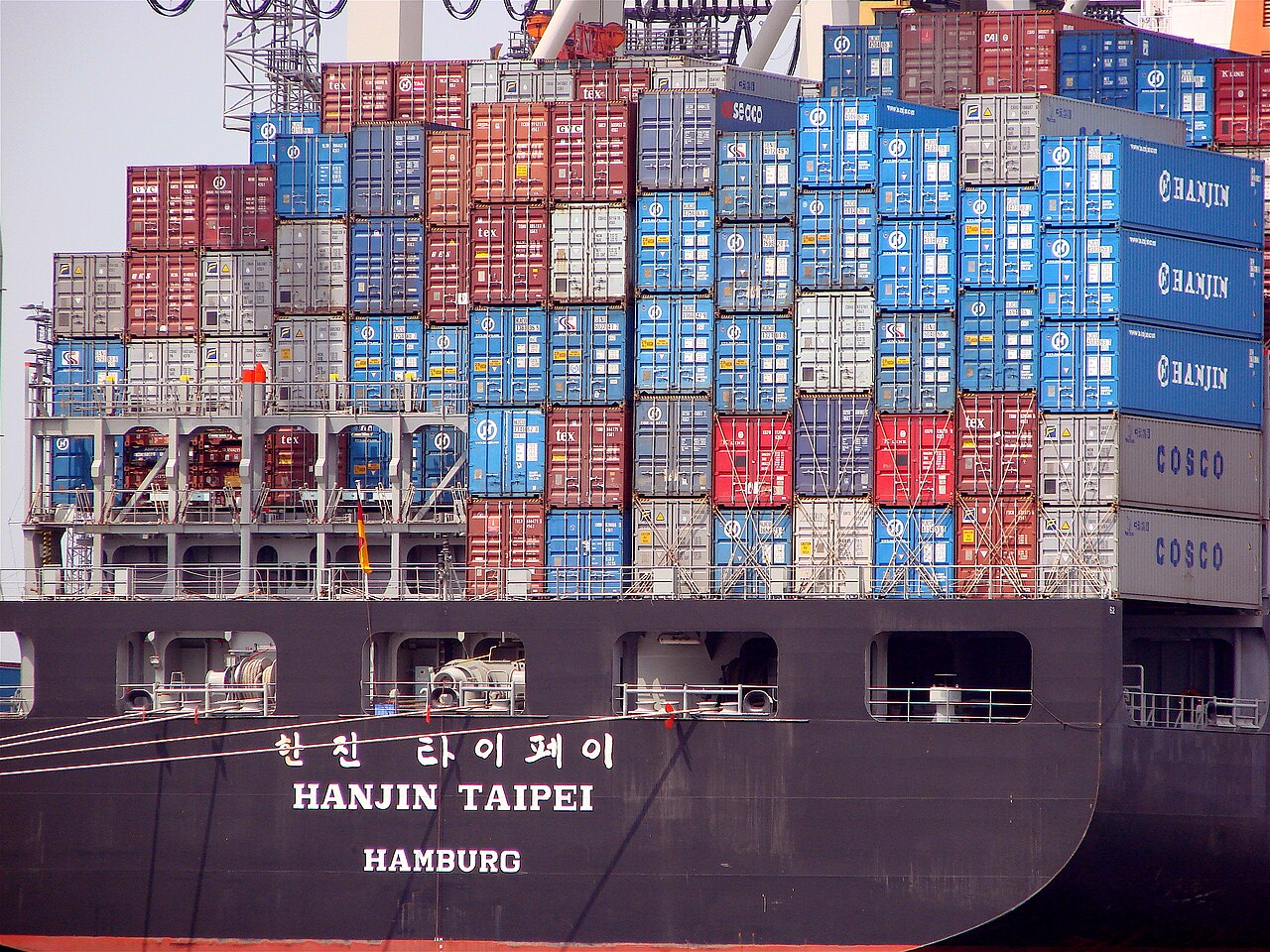 A container ship carrying international freight; cross-border goods are central to the tariff dispute.